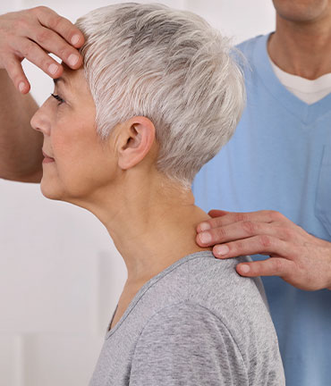 Patient receiving chiropractic adjusmtent for migraine relief from Lake Worth Chiropractors