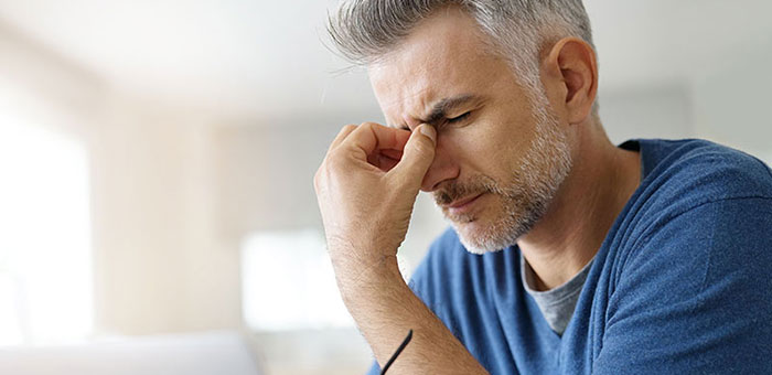 Man suffering with migraine before visiting Lake Worth chiropractor