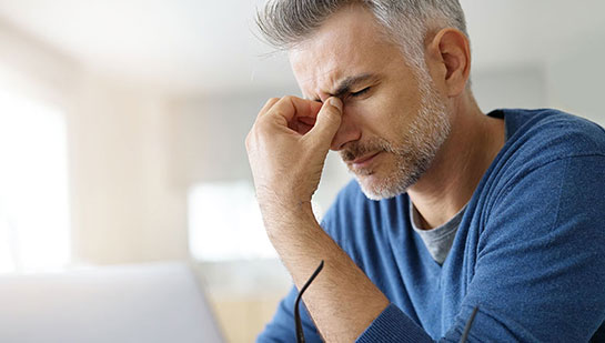 Man suffering with migraine before visiting Lake Worth chiropractor