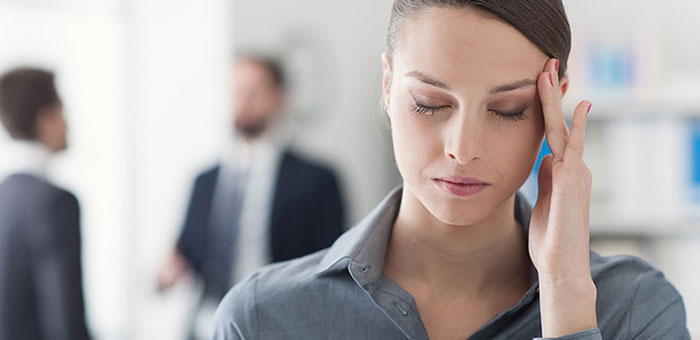 Woman with migraine needing a Lake Worth chiropractor