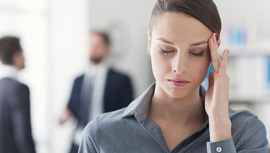 Woman with migraine needing a Lake Worth chiropractor