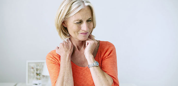 Mature woman suffering from neck and shoulder pain before visiting Lake Worth chiropractor