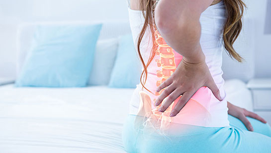 Woman suffering from subluxation in lower back before visiting Lake Worth chiropractor