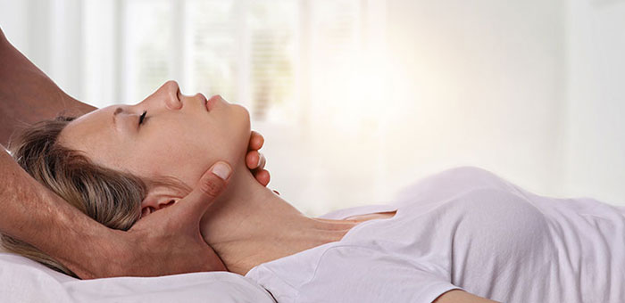 Woman receiving neck adjustment from Lake Worth chiropractor