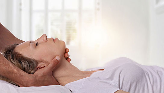 Woman receiving neck adjustment from Lake Worth chiropractor