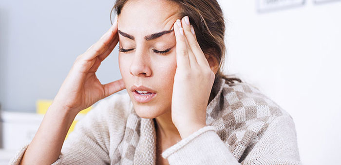 Woman suffering from headache before visiting Lake Worth chiropractor