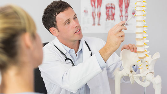 Lake Worth chiropractor explaining spine misalignments to patient